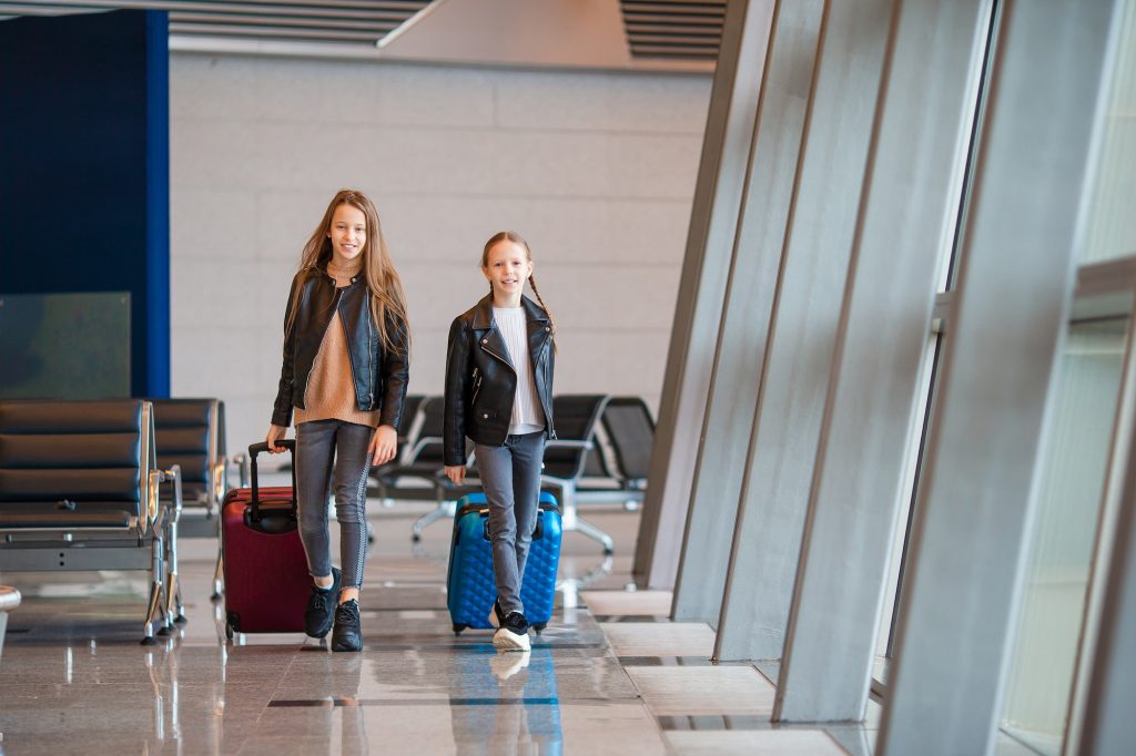 Little kid in airport waiting for boarding